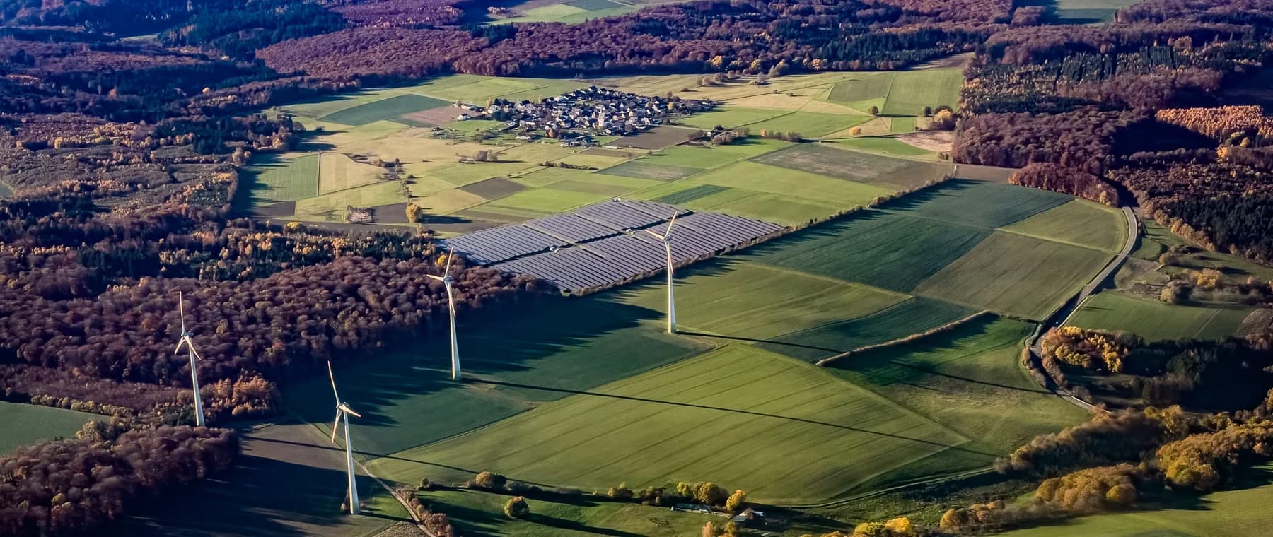 Wind turbines and solar panels in a rural landscape